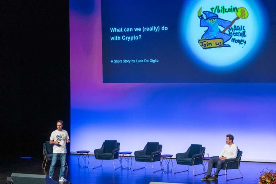 Luca on stage in Zug presenting What can we really do with crypto